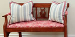 upholstered settee with down pillows and trim